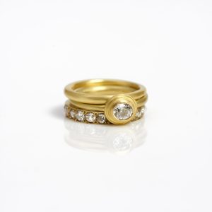 18 carat gold diamond ring stack - single oval diamond ring, eternity ring with pavé-set diamonds and a plain spacer ring 18 carat gold diamond ring stack - single oval diamond ring, eternity ring with pavé-set diamonds and a plain spacer ring