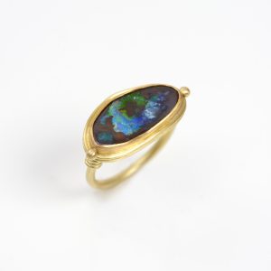18 carat gold ring with freeform boulder opal set in 22 carat gold, granules and twists on the shoulders 18 carat gold ring with freeform boulder opal set in 22 carat gold, granules and twists on the shoulders